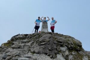 (L to R) Matthew Blamires, Will Edmonson and Joe Davey pictured on Ben Nevis wearing Better Lives charity t-shirts