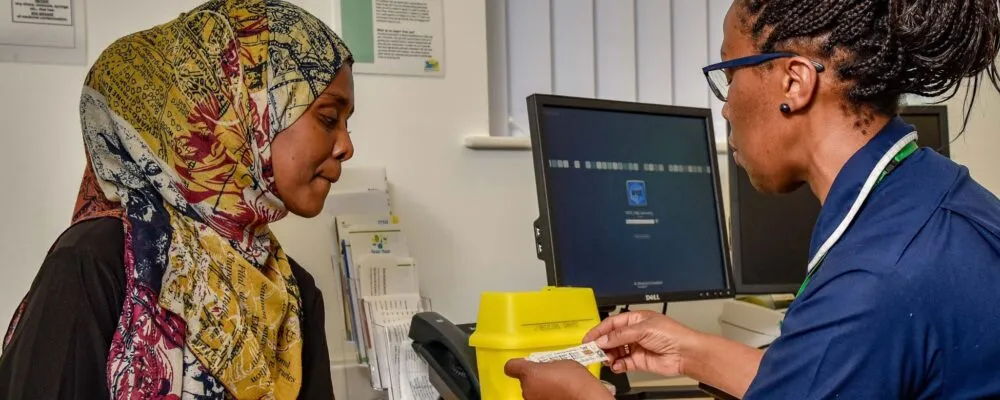 A photograph of a patient with a nurse