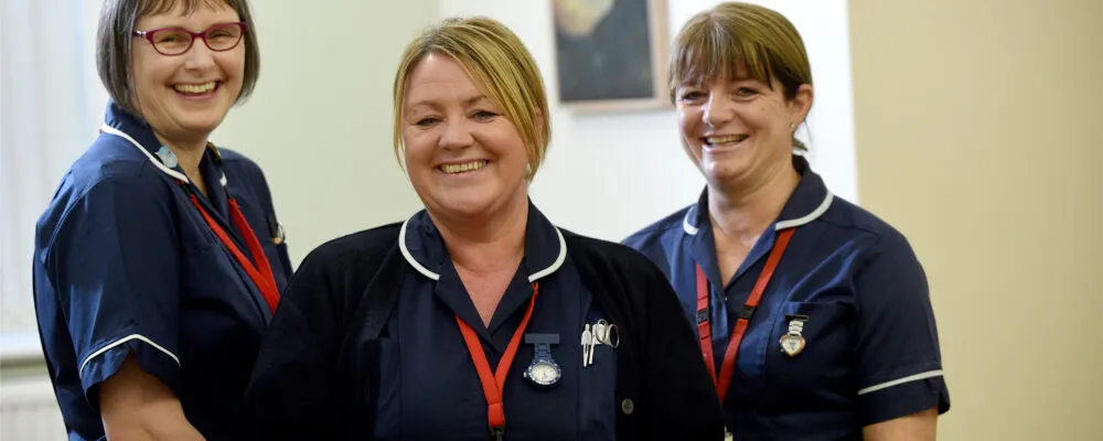 Three nurses smiling